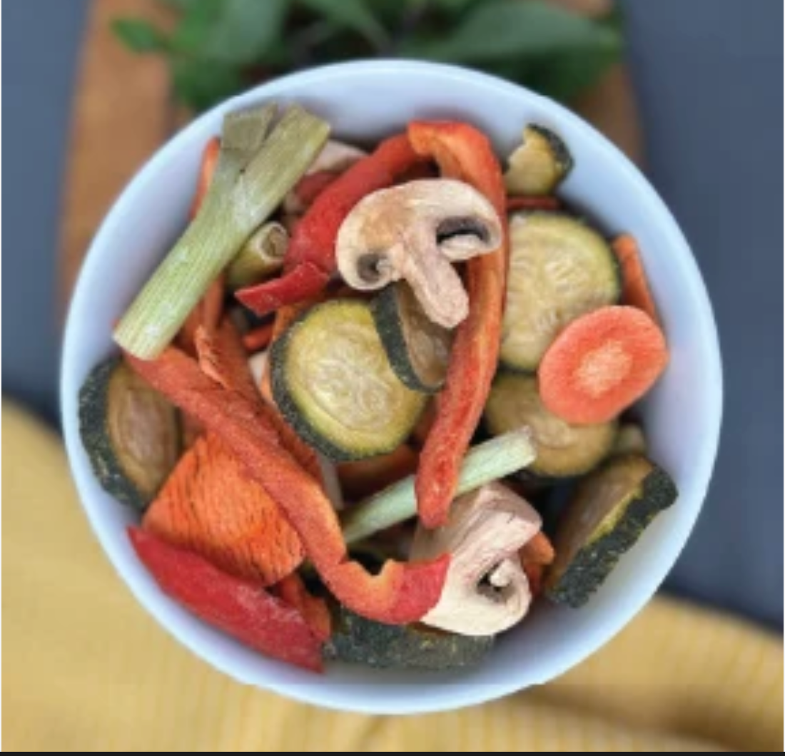 A bowl of Fresh Dry veggie crisps with carrots, peppers, zucchini, and mushrooms